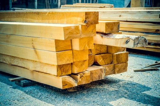 Sawmill. Warehouse for sawing boards on a sawmill outdoors. Wood timber stack of wooden blanks construction material