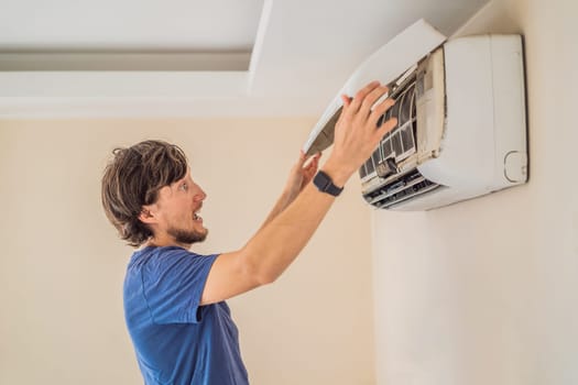 technician service removing air filter of the air conditioner for cleaning.