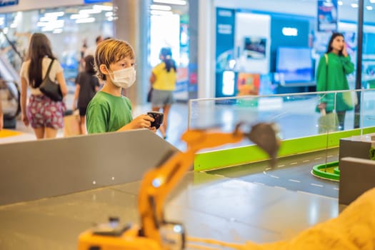 Adorable cute little child playing with toy on remote control, in the mall. Happy kid boy having fun. Leisure, lifestyle for kids concept.