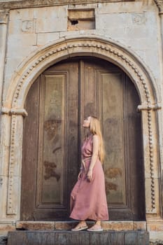 Woman tourist in Old town Kaleici in Antalya. Turkiye. Panoramic view of Antalya Old Town port, Taurus mountains and Mediterrranean Sea, Turkey.