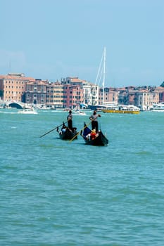 Venice, Italy - 06/08/2009 - Tourists visiting Venice on the characteristic Venetian gondolas