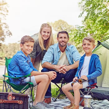 We love camping. Cropped portrait of a family of four camping in the woods