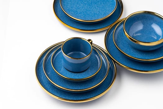 A set of blue ceramic plates and cup on a white background