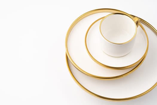 A set of white and brown ceramic plate and cup on a white background