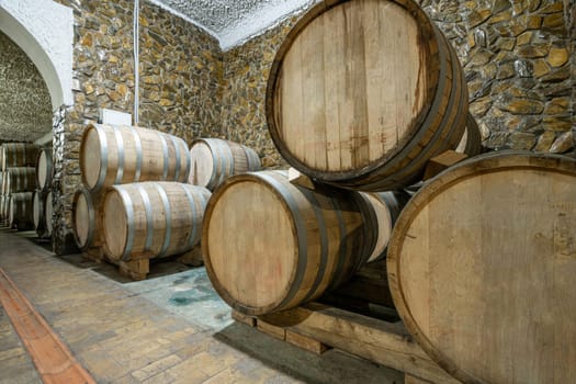 The wooden wine barrels in a wine factory