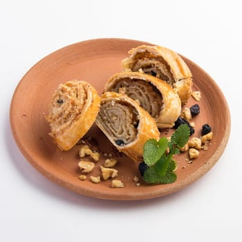 A beautiful shot of tasty sweet rolls with walnuts, raisins and sugar
