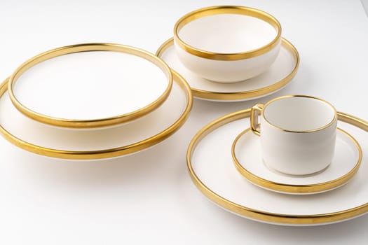 A set of white and brown ceramic plate and cup on a white background