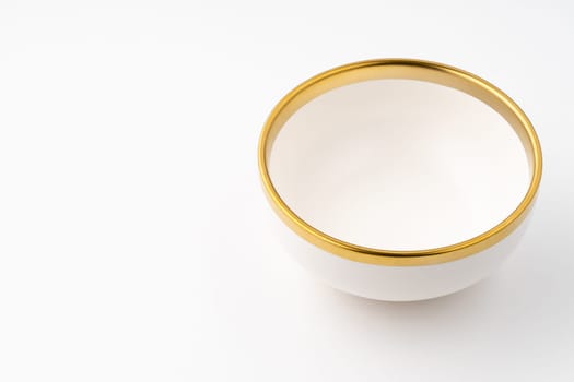 A white and brown ceramic bowl on a white background