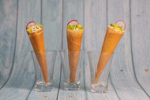 Brick cone with tuna sauce, mayonnaise, avocado and radish slice, High quality photo