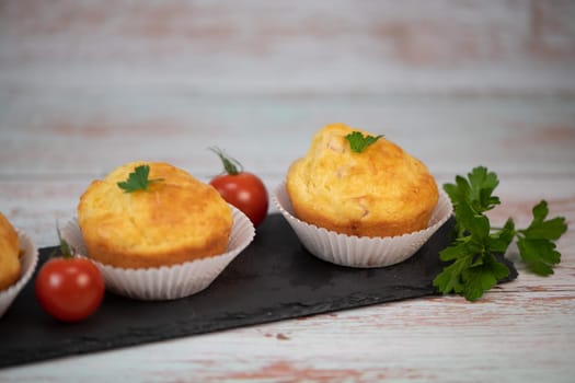 Savory muffin with ham and cheese on blue background, High quality photo