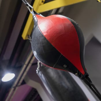 A vertical closeup of a boxing punching bag in the sports complex