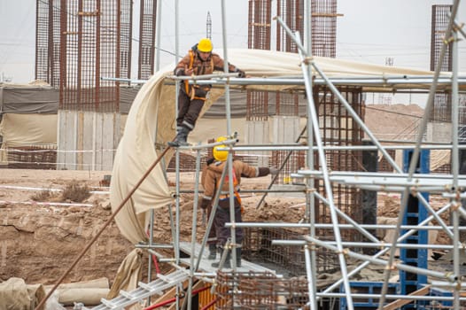 A workers with special equipment in a construction site make formwork