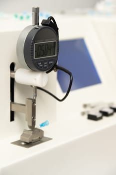 A vertical closeup shot of equipment in a medical laboratory for manufacturing medical syringes