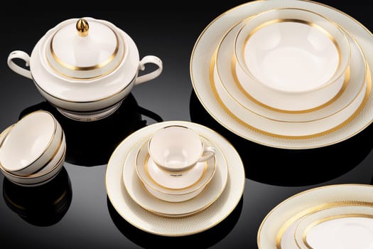 A luxury tableware set on black reflective surface