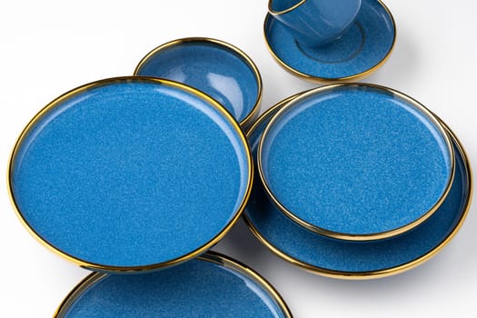 A set of blue ceramic plates and cup on a white background