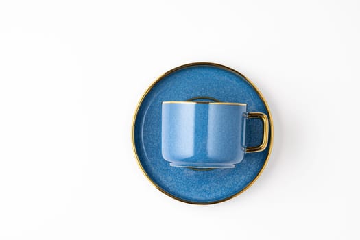 A set of blue ceramic plates and cup on a white background. Top view