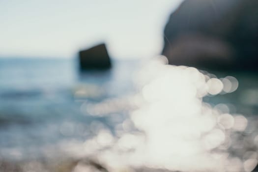 Abstract nature summer or spring ocean sea background. Small waves on water surface in motion blur with bokeh lights from sunrise.