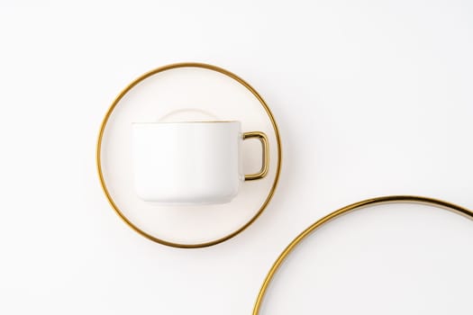 A set of white and brown ceramic plate and cup on a white background. Top view