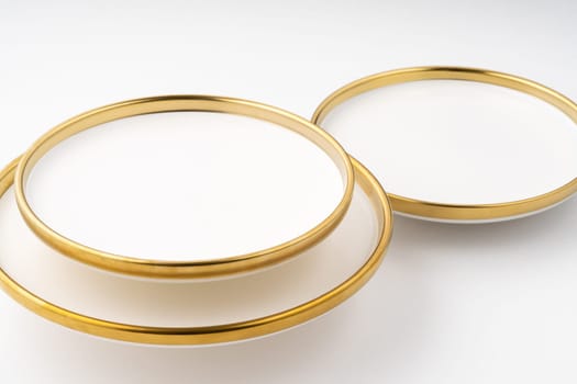 A set of white and brown ceramic plates on a white background