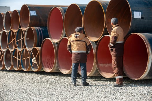 A line of oilfield large streel pipes in industrial construction area