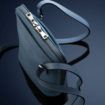 A closeup shot of a luxury blue leather bag