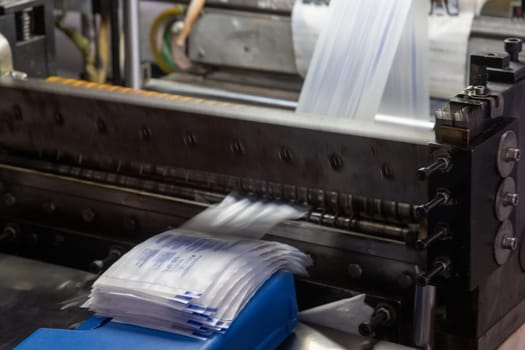 A closeup shot of a machine printing syringe labels at a medical production warehouse