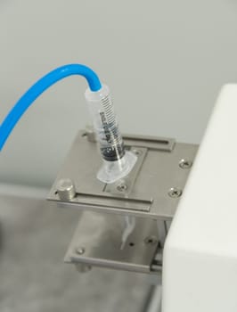A closeup of the production and testing of medical syringes and droppers