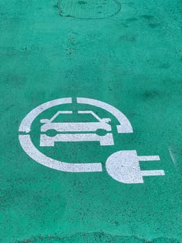 Loreto, Ancona, Italy - April 2023 Charging station for electric vehicles near the walls of Basilica sign and parking space for 2 cars