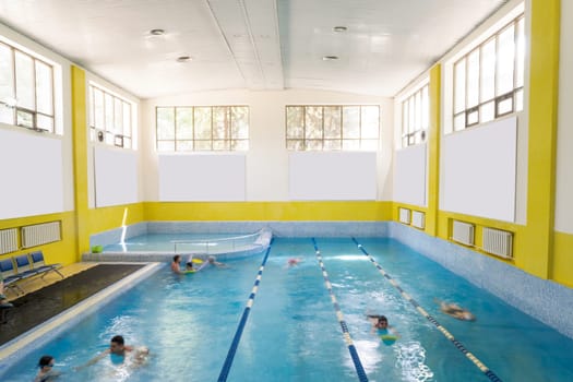 A swimming pool sectioned into 4 rows inside a a sports wellness center