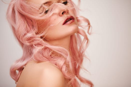 Soft-Girl Style with Trend Pink Flying Hair, Fashion Make-up. Woman Face with Fake Freckles and Rose Flowers. Blonde Female Model with perfect Fresh Clean Skin, Blush Rouge