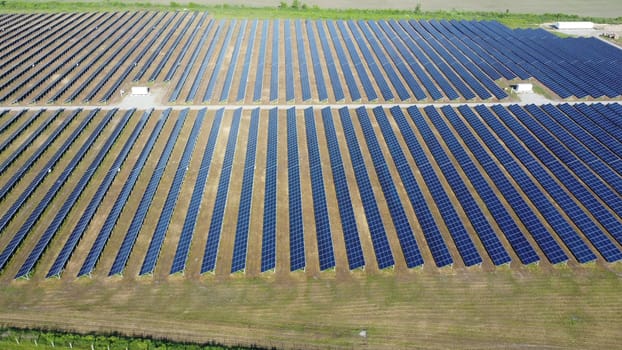 Solar power plant. Many blue panels of a large solar power plant. Aerial drone view. Solar power station. Green clean electricity. New modern technologies. Ecological alternative innovation technology