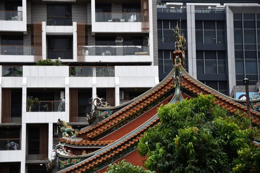 View of a roof of a historic temple in front of a modern building in Taipei, Taiwan