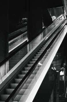 Vertical grayscale shot of the metro station escalator. Ruhr area, Germany.