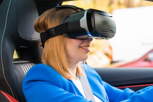 Business woman in the VR googles sitting in the car and turning the steering wheel in a car. Having fun and playing games with augmented reality