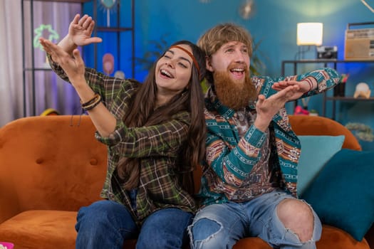Cheerful rich family marriage hippie couple man woman showing wasting or throwing money around hand gesture, more tips earnings, big profit, win lottery, body language, share at home. Husband wife