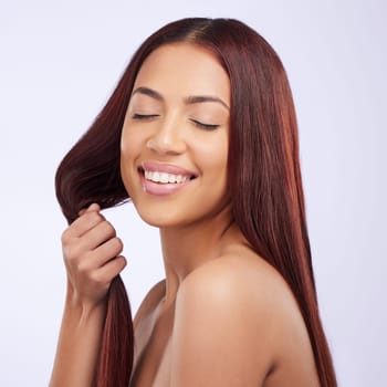 Haircare, beauty and happy woman holding hair, strong hairstyle and luxury salon color isolated on white background. Keratin care, haircut and happiness, Brazilian model with smile on studio backdrop.