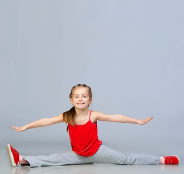 beautiful girl sits on a splits