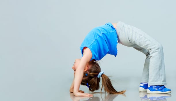 Little girl doing gymnastics exercise