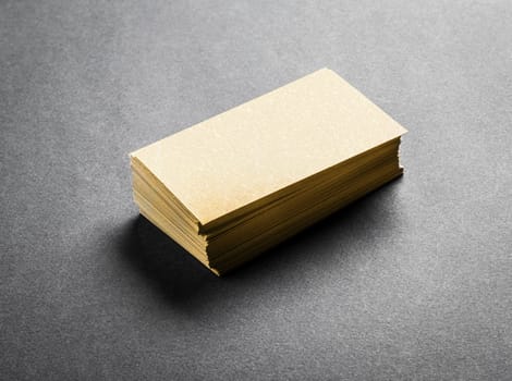 Stack of blank golden business card on grey background. Blank name card.