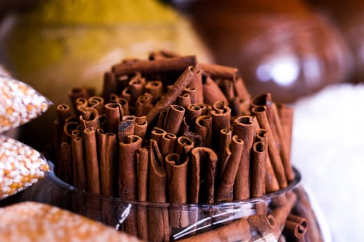 Cinnamon sticks in glass vase selling on market