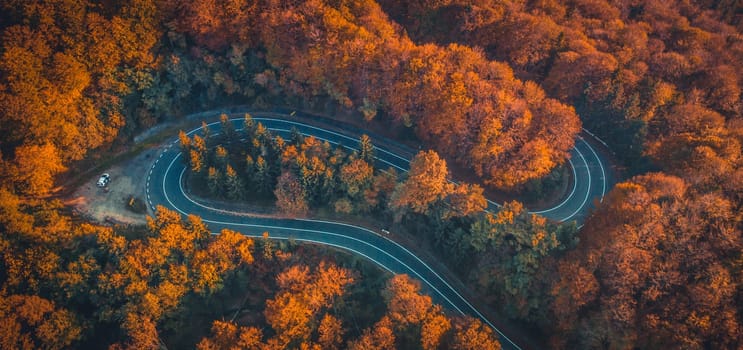 Transfagarasan serpentine going through autumn forest