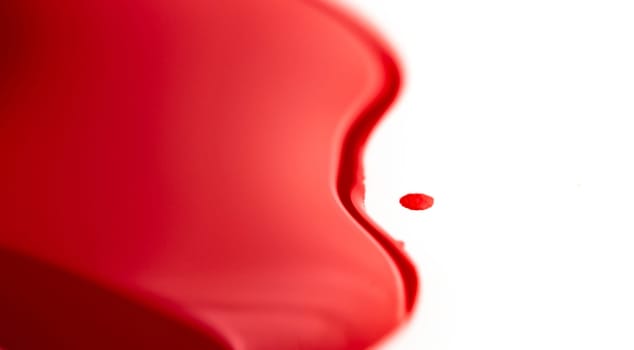 Glossy red stain of paint isolated on white background