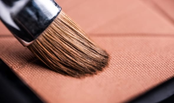 Makeup brush and set of pastel shadows