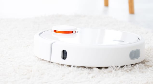 Wireless robot hoover on white rug
