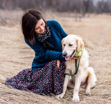 Active dog with pretty woman outside