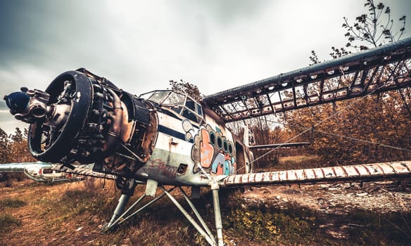 Vovchansk, Ukraine - 15 May 2020: Abandoned old destroyed USSR airplane on the airfield with burnt rotor