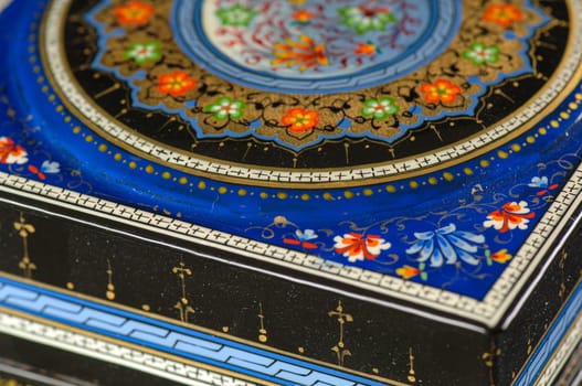 A closeup of a casket with an artistic painting on a black background. Central Asia, Uzbekistan