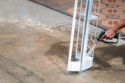 Worker to cleaning coil cooler of air conditioner by water for clean a dust on the wall in customer home when maintenance service