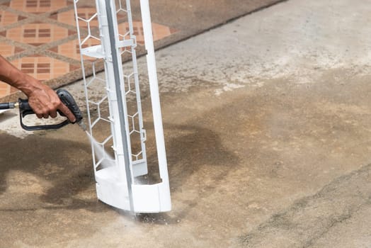 Worker to cleaning coil cooler of air conditioner by water for clean a dust on the wall in customer home when maintenance service