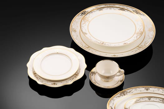 A luxury tableware set on black reflective surface